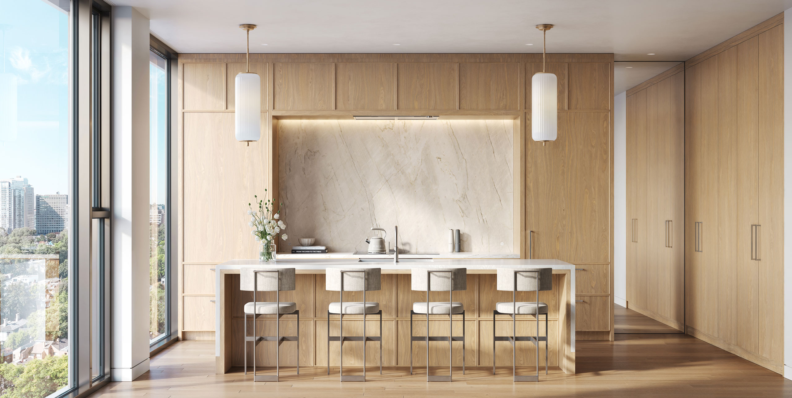 Kitchen with full-height oak cabinetry, natural stone and an oversized waterfall island